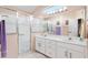 Bright bathroom with a dual sink vanity and a glass-enclosed shower at 3909 River Crest Cir, Leesburg, FL 34748
