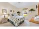 Well-lit bedroom features a vaulted ceiling, a ceiling fan, and a window with green view at 3909 River Crest Cir, Leesburg, FL 34748