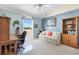 Inviting bedroom with neutral colored walls, a ceiling fan, and views of the community's greenery at 3909 River Crest Cir, Leesburg, FL 34748