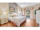 Comfortable bedroom with wood floors, neutral walls, and a sliding glass door at 3909 River Crest Cir, Leesburg, FL 34748