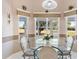 Eat-in kitchen nook with glass table, decorative wainscoting, lots of light, and beautiful backyard views at 3909 River Crest Cir, Leesburg, FL 34748