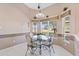 Breakfast nook with a glass table, decorative wainscoting, lots of light, and backyard views at 3909 River Crest Cir, Leesburg, FL 34748