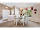 Cozy dining room featuring a glass dining table and a window bringing in natural light to enjoy meals at 3909 River Crest Cir, Leesburg, FL 34748
