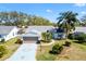 Beautiful single-story home with a patterned driveway, two-car garage, and manicured front yard at 3909 River Crest Cir, Leesburg, FL 34748