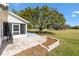 Outdoor patio area adjacent to a well-maintained lawn and a screened-in porch, perfect for entertaining at 3909 River Crest Cir, Leesburg, FL 34748