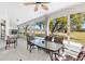 Bright sunroom featuring a glass table, chairs, tile flooring and expansive views of the outdoors at 3909 River Crest Cir, Leesburg, FL 34748
