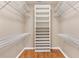 Spacious walk-in closet with custom shelving and hardwood floors at 3909 River Crest Cir, Leesburg, FL 34748