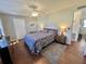 Cozy bedroom with a comfortable bed, wood floors, and warm lighting from bedside lamps at 405 Hawthorne Blvd, Leesburg, FL 34748