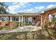 Charming front porch of brick home with patriotic decor, plants, and a seating area at 4107 Dove Valley Ln, Lady Lake, FL 32159