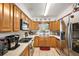 Functional kitchen with stainless steel appliances, wooden cabinets and a window above the sink at 4107 Dove Valley Ln, Lady Lake, FL 32159