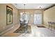Bright dining area featuring a chandelier, animal print rug, a window, and front door with decor at 4818 Sawgrass Lake Cir, Leesburg, FL 34748