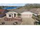 Lovely waterfront home featuring a well-maintained lawn, two-car garage, and picturesque lake views at 4818 Sawgrass Lake Cir, Leesburg, FL 34748