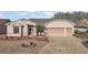 Well maintained single-story home with manicured landscaping and a two-car garage at 4818 Sawgrass Lake Cir, Leesburg, FL 34748