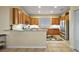 Bright kitchen featuring stainless steel appliances, ample wood cabinetry, and a breakfast bar at 4818 Sawgrass Lake Cir, Leesburg, FL 34748