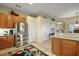 Kitchen featuring stainless steel refrigerator and access to breakfast bar and adjacent rooms at 4818 Sawgrass Lake Cir, Leesburg, FL 34748