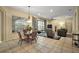Open concept living area with tile floors, a view of the patio, and seamlessly connects living spaces at 4818 Sawgrass Lake Cir, Leesburg, FL 34748