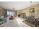 Inviting living room with large windows overlooking the outdoors and a view of the dining room at 4818 Sawgrass Lake Cir, Leesburg, FL 34748