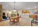 Open-concept living room and kitchen area with tile flooring and decorative furnishings at 4818 Sawgrass Lake Cir, Leesburg, FL 34748