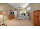 Large main bedroom featuring a vaulted ceiling, neutral paint, and walk through to the bathroom at 4818 Sawgrass Lake Cir, Leesburg, FL 34748