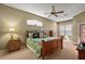 Spacious main bedroom featuring a ceiling fan, neutral paint, and large windows at 4818 Sawgrass Lake Cir, Leesburg, FL 34748