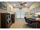 Bright office with a ceiling fan, desk, and built-in shelving units at 4818 Sawgrass Lake Cir, Leesburg, FL 34748