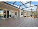 Outdoor patio with screened enclosure, tiled floor, and lake views at 4818 Sawgrass Lake Cir, Leesburg, FL 34748