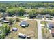 This aerial showcases the home, storage shed, fenced yard, and proximity to other neighborhood homes at 4857 Se 137Th Pl, Summerfield, FL 34491