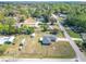 Aerial view of the property showing the home, surrounding neighborhood, and expansive lawn at 4857 Se 137Th Pl, Summerfield, FL 34491