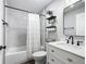 Elegant bathroom featuring a bathtub-shower, white vanity with countertop, and stylish decor at 4857 Se 137Th Pl, Summerfield, FL 34491