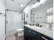 Modern bathroom featuring a glass-enclosed shower, stylish vanity with countertop, and sleek black fixtures at 4857 Se 137Th Pl, Summerfield, FL 34491