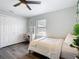 Well-lit bedroom featuring a vanity desk, a ceiling fan, and a cozy bed with a decorative throw at 4857 Se 137Th Pl, Summerfield, FL 34491