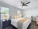 A Primary bedroom with a queen bed, a crib, and hardwood floors at 4857 Se 137Th Pl, Summerfield, FL 34491