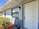 Inviting front entrance with a new door, modern light fixture, and landscaped shrubbery at 4857 Se 137Th Pl, Summerfield, FL 34491