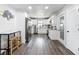 Modern kitchen featuring all white cabinetry, stainless steel appliances, and durable plank flooring at 4857 Se 137Th Pl, Summerfield, FL 34491