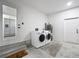 Functional laundry room with washer, dryer, water heater, and convenient access to other areas at 4857 Se 137Th Pl, Summerfield, FL 34491