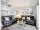 Spacious living room with modern decor, comfortable seating, and views of the backyard at 4857 Se 137Th Pl, Summerfield, FL 34491