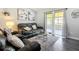 Inviting living room featuring stylish furnishings, a modern rug, and natural light at 4857 Se 137Th Pl, Summerfield, FL 34491