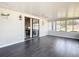 Bright sunroom with windows, sleek tile flooring, and serene views of the surrounding landscape at 4857 Se 137Th Pl, Summerfield, FL 34491