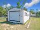 Backyard storage shed with roll-up door and plenty of space for tools and equipment at 4857 Se 137Th Pl, Summerfield, FL 34491