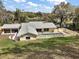 Aerial view of house, backyard and pool from above at 502 Lake Gracie Dr, Eustis, FL 32726