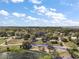 Aerial view of property showcasing its lot size, surrounding trees, lake and neighborhood location at 502 Lake Gracie Dr, Eustis, FL 32726