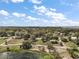 Discover this lakeside home nestled among lush greenery, offering serene views and a tranquil escape under a bright, partly cloudy sky at 502 Lake Gracie Dr, Eustis, FL 32726