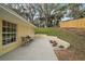 Back patio with a small table and chairs and a view of the backyard at 502 Lake Gracie Dr, Eustis, FL 32726