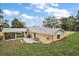 Expansive backyard with a patio, chain link fence and a covered parking area at 502 Lake Gracie Dr, Eustis, FL 32726