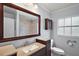 Bathroom featuring a modern vanity, a toilet, and a shower with marble tiling at 502 Lake Gracie Dr, Eustis, FL 32726
