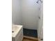 Bathroom featuring modern sink, shower with black basin, white horizontal planks and tiled floors at 502 Lake Gracie Dr, Eustis, FL 32726