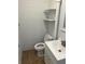 Neat bathroom featuring white horizontal planks, a toilet, sink and tiled floors at 502 Lake Gracie Dr, Eustis, FL 32726
