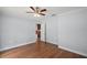Spacious bedroom featuring beautiful hardwood floors and a ceiling fan at 502 Lake Gracie Dr, Eustis, FL 32726