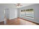 Bedroom boasts wood floors, ceiling fan, and a window view of the pool at 502 Lake Gracie Dr, Eustis, FL 32726