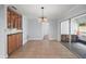 Dining area includes chandelier and wet bar with sliding glass doors leading to the pool at 502 Lake Gracie Dr, Eustis, FL 32726
